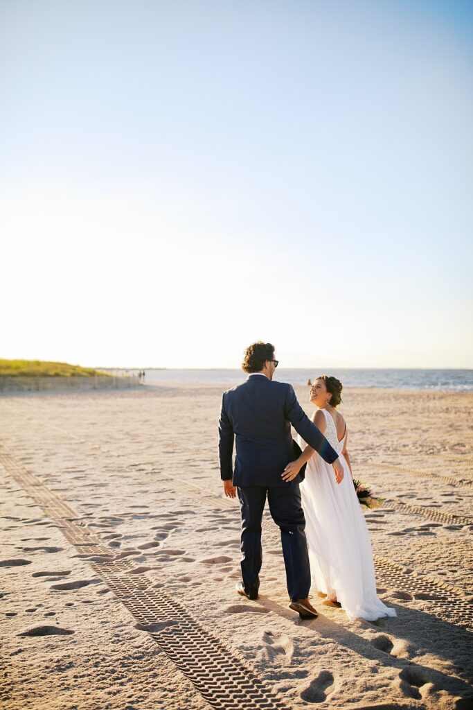A couple leaves their ceremony on the beach.