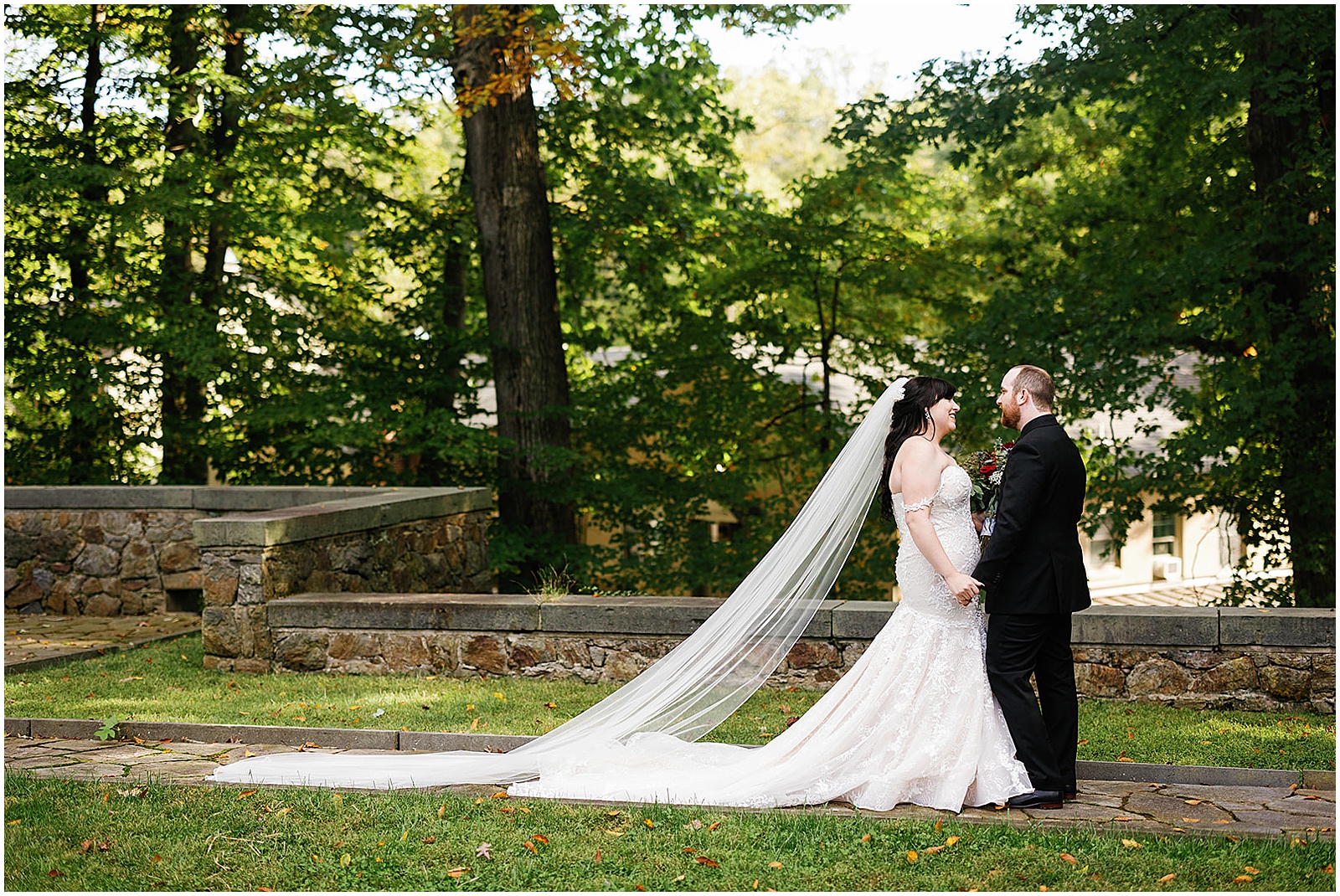 A bride and groom hold hands after their first look at their wedding at Winterthur.