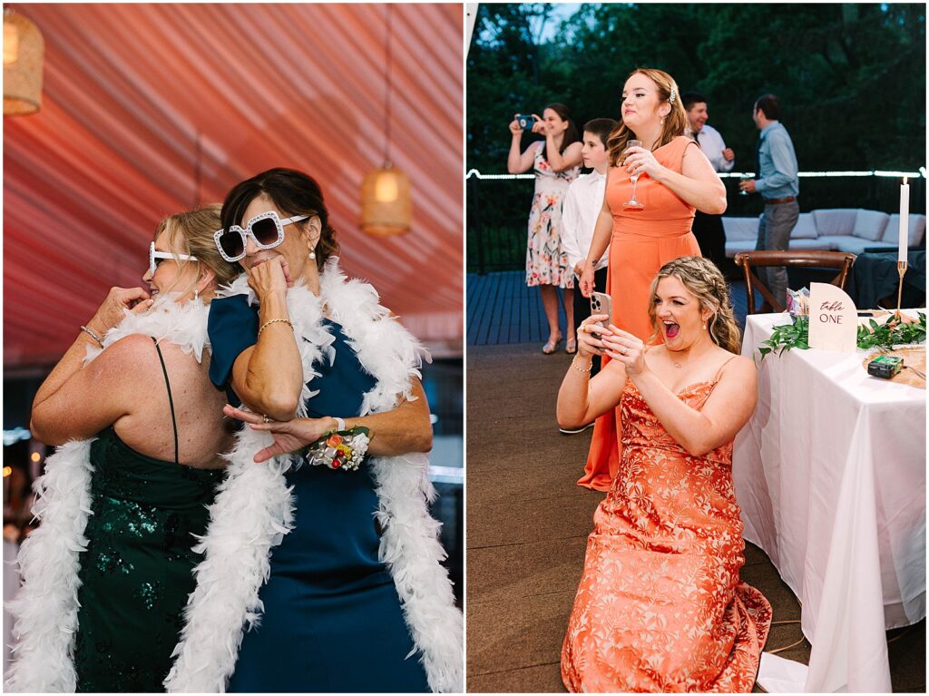 Bridesmaids in orange dresses laugh and record a video on their phones.