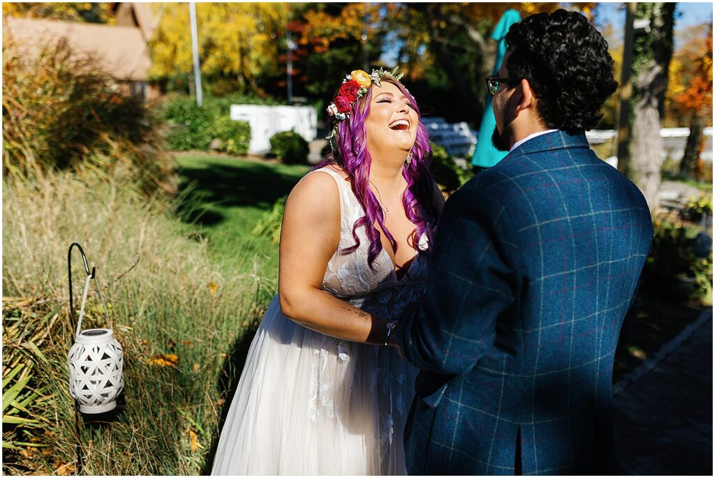 A bride laughs during her first look with her groom at their New Jersey wedding.