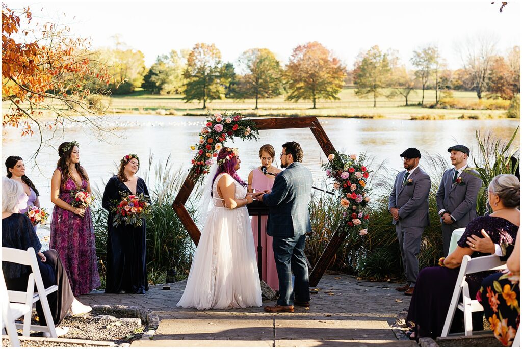 A bride and groom exchange vows at the Estate at Eagle Lake.