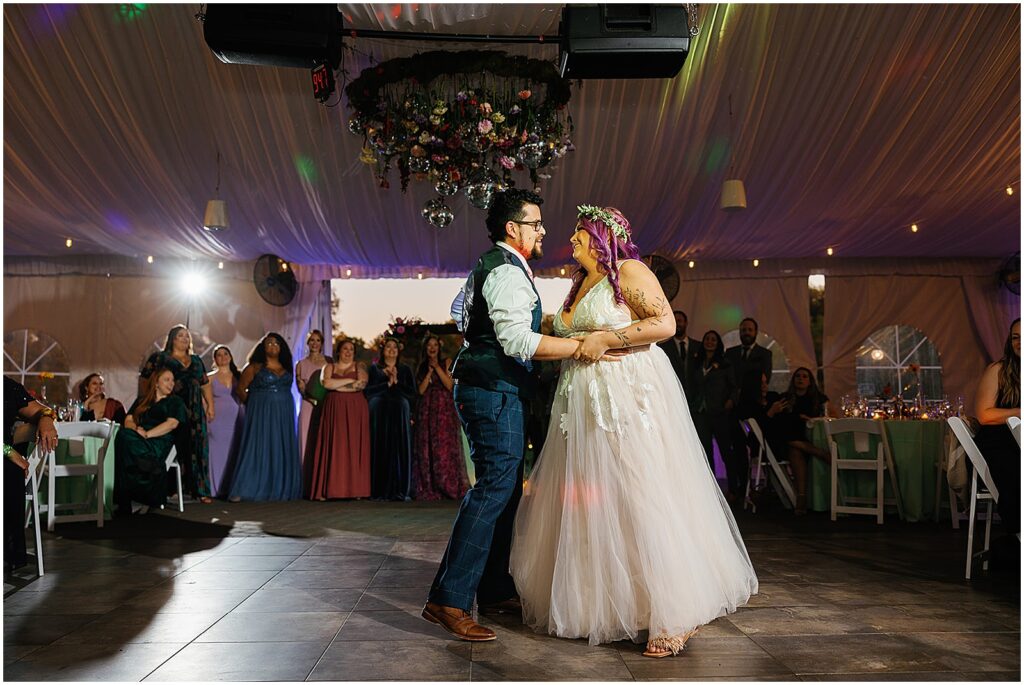 A bride and groom share a first dance at the the estate at eagle lake.