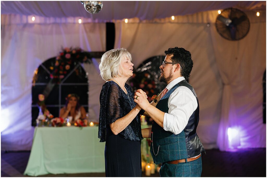 A groom dances with his mother.