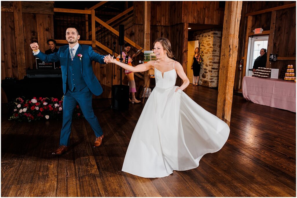 A bride and groom enter their reception.