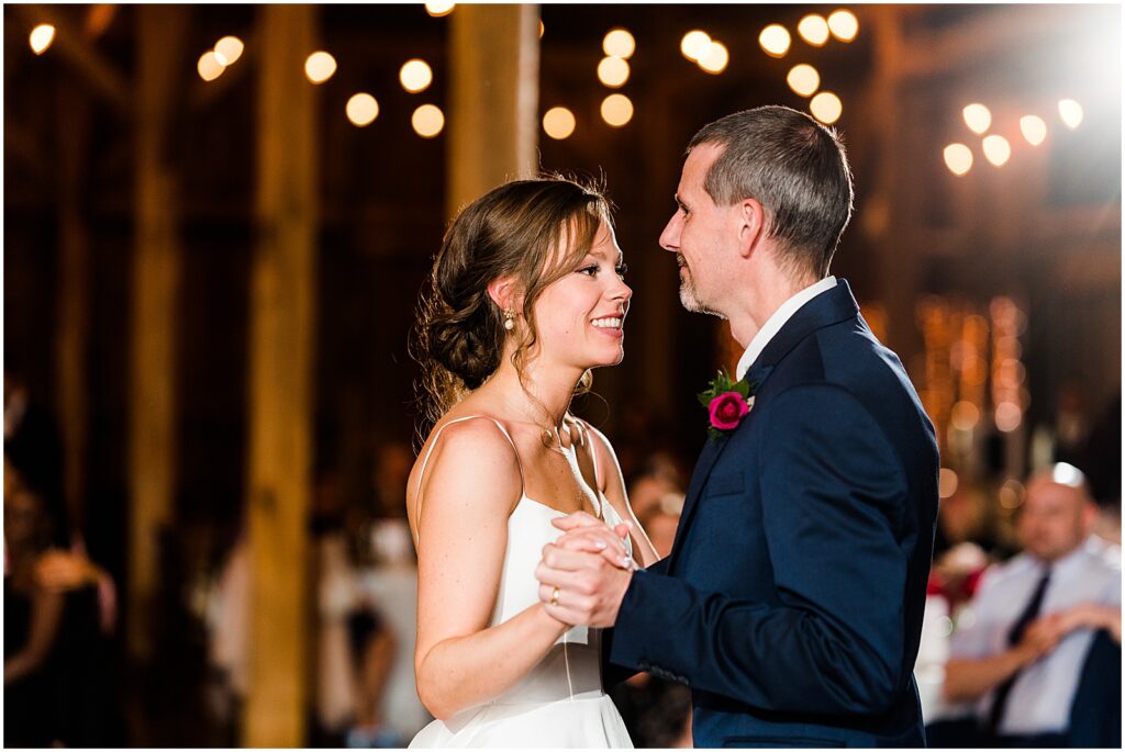 A bride smiles during the father-daughter dance.