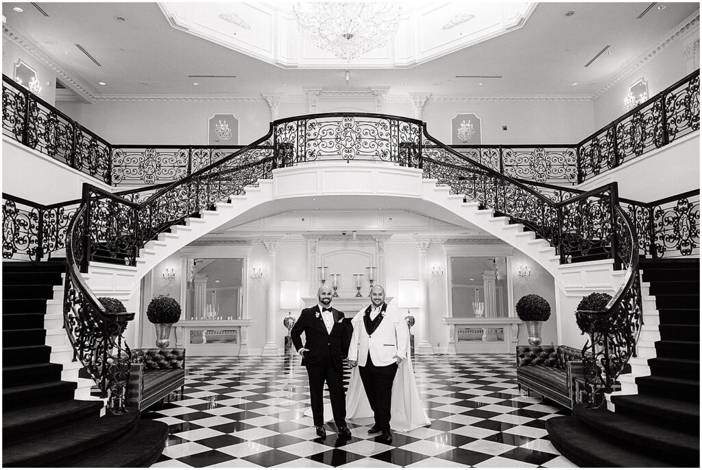 Two grooms pose in the entry hall of the Addison Park.