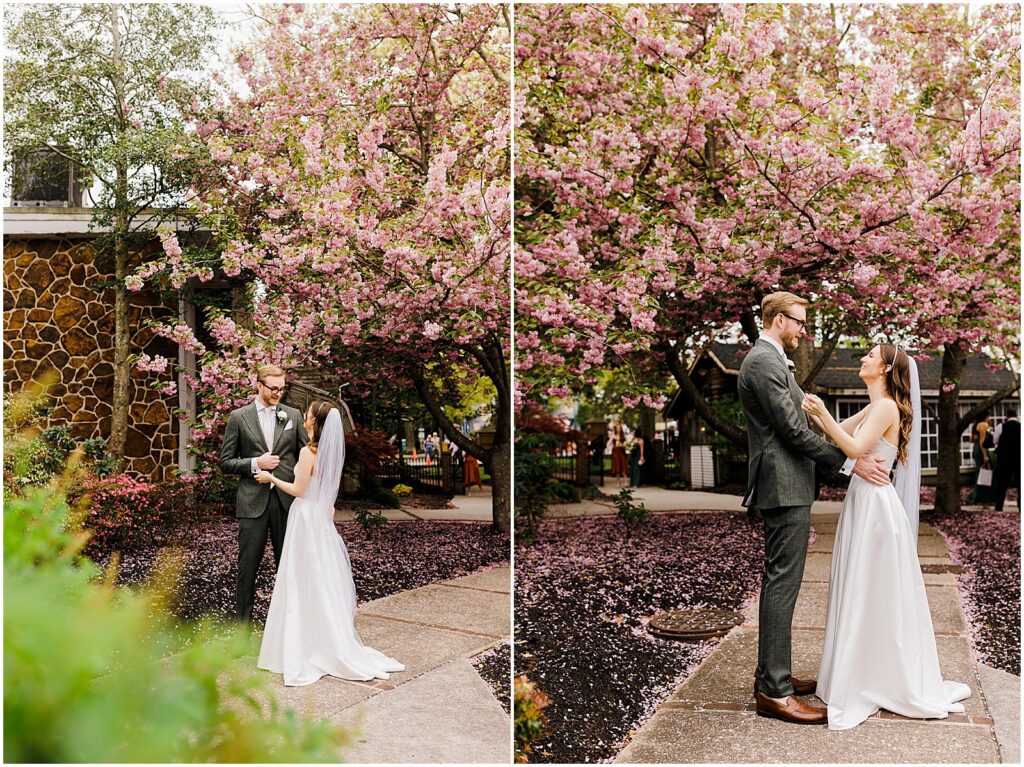 A groom reacts to seeing a bride beneath a cherry tree during their first look at the historic smithville inn.
