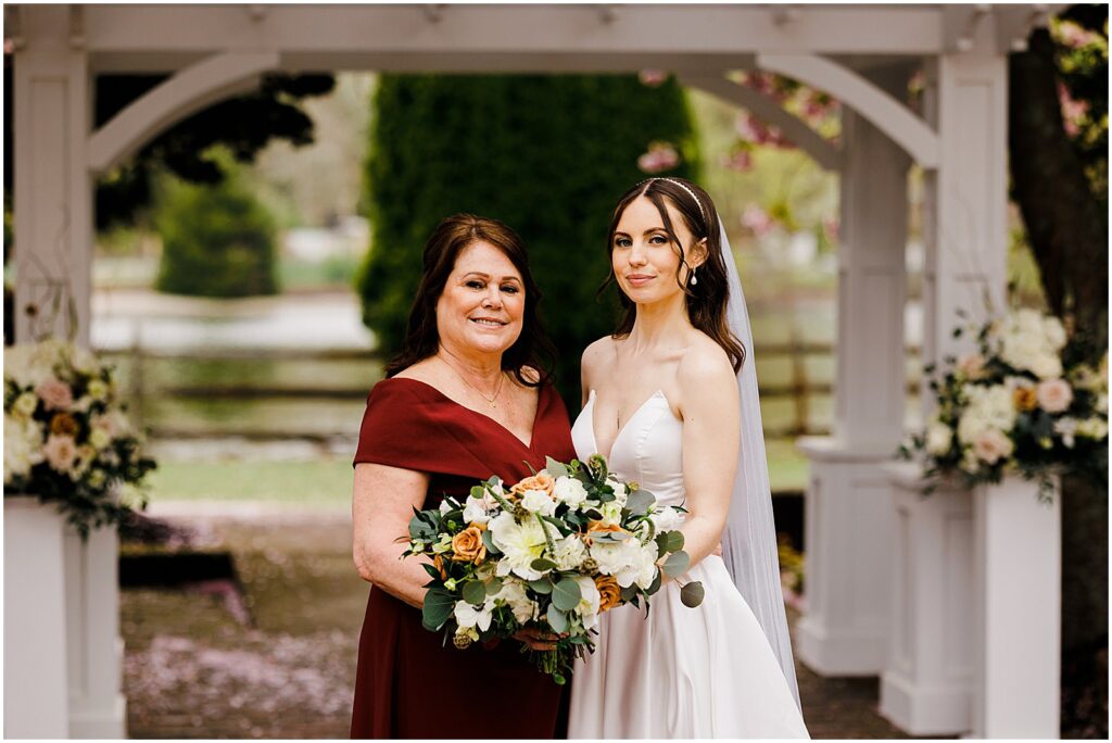 A bride poses with her mother for a New Jersey wedding photographer.