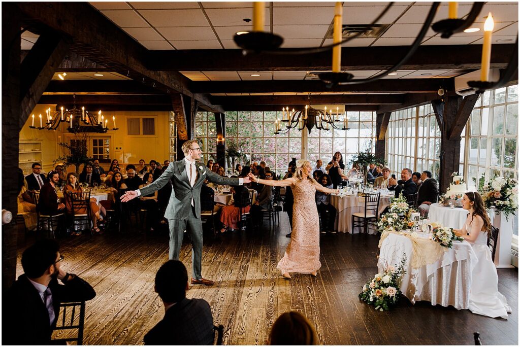 A groom spins his mother on the dance floor at the historic smithville inn.