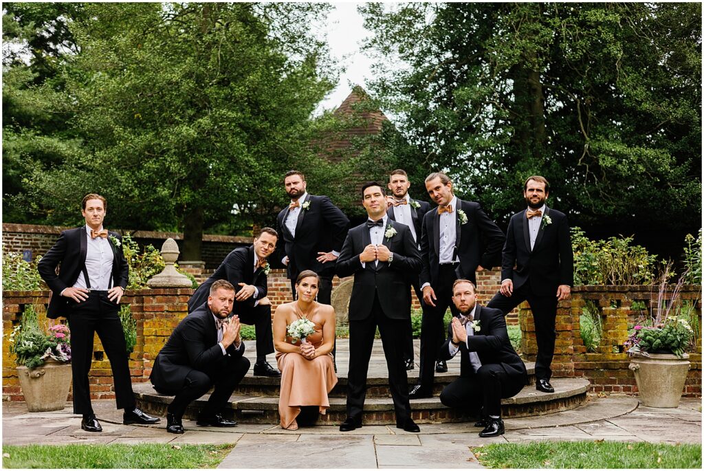 A groom poses with his wedding party.