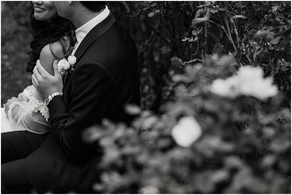 A bride and groom kiss in the garden at Aldie Mansion.