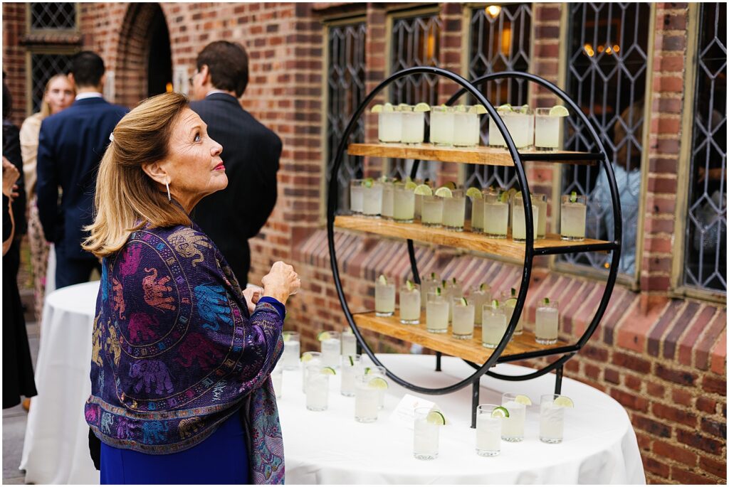 A guest takes a cocktail from a display in the courtyard of Aldie Mansion.