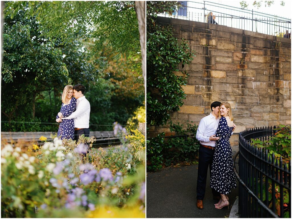 A man and woman pose beside a flower garden for Brooklyn engagement photos.