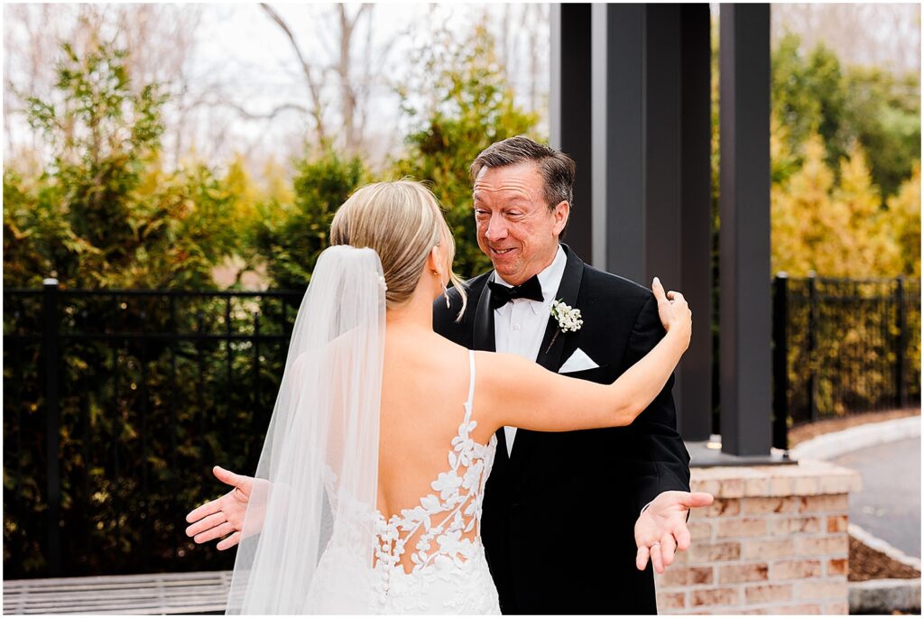 A bride hugs her father at her first look with him.