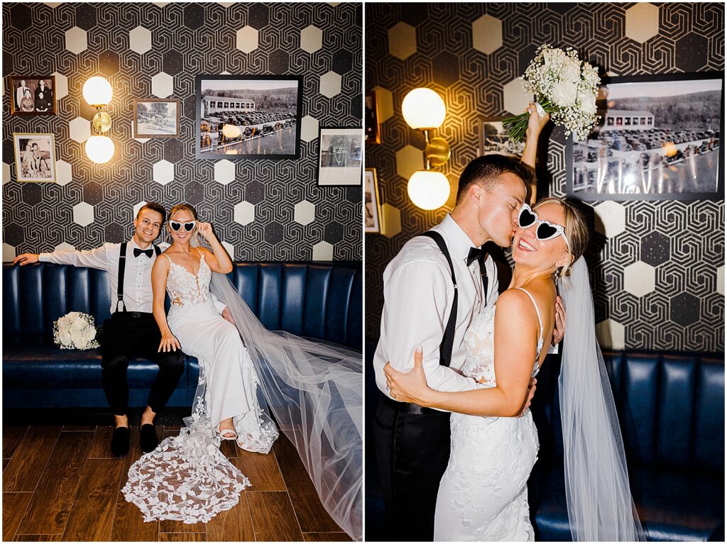 A groom kisses a bride wearing heart-shaped sunglasses in a room at Perona Farms.