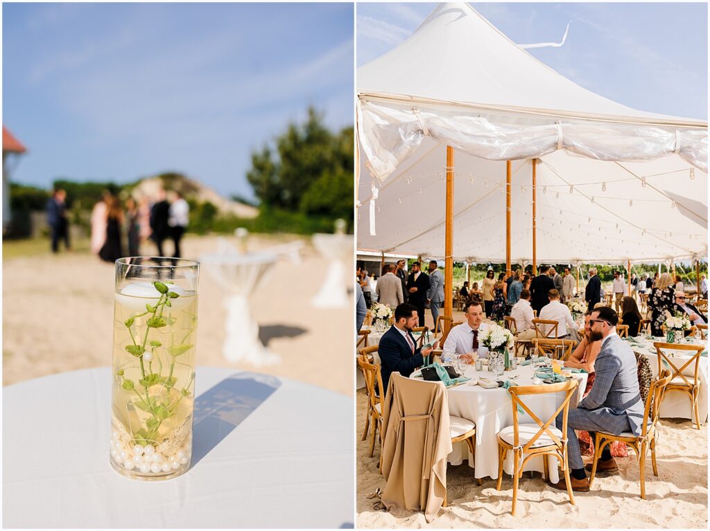 Guests sit at small tables under a white tent at a beach wedding.