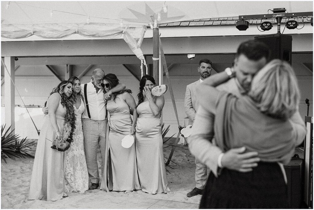 Family members cry as a groom dances with his aunt.