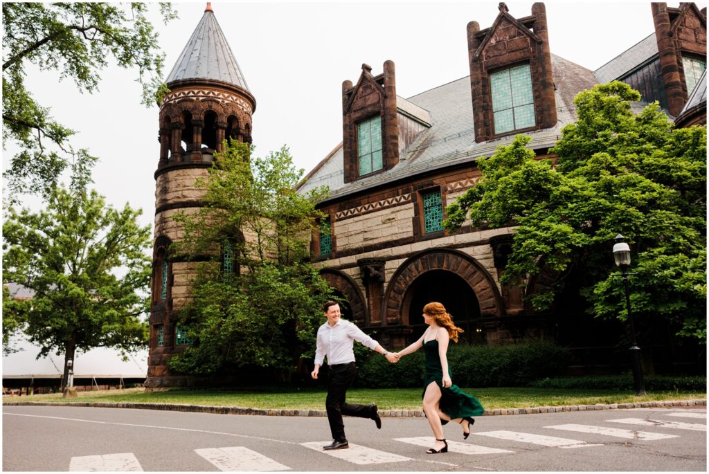A man and woman run across a Princeton street during an engagement session.