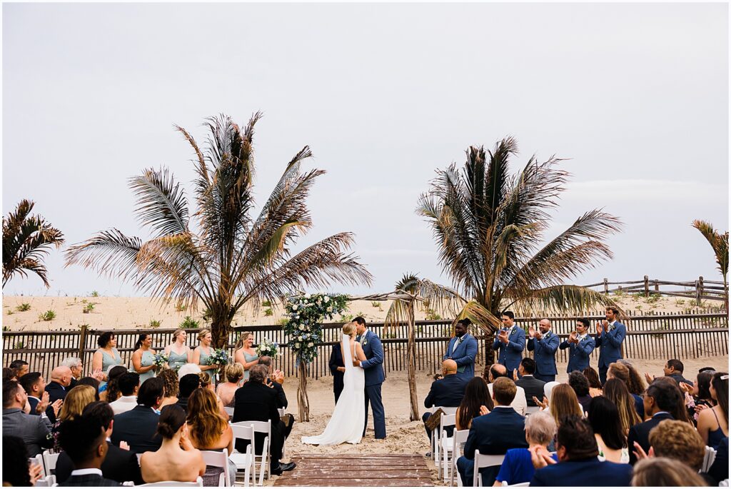 A bride and groom share their first kiss at a Sea Shell Resort wedding.