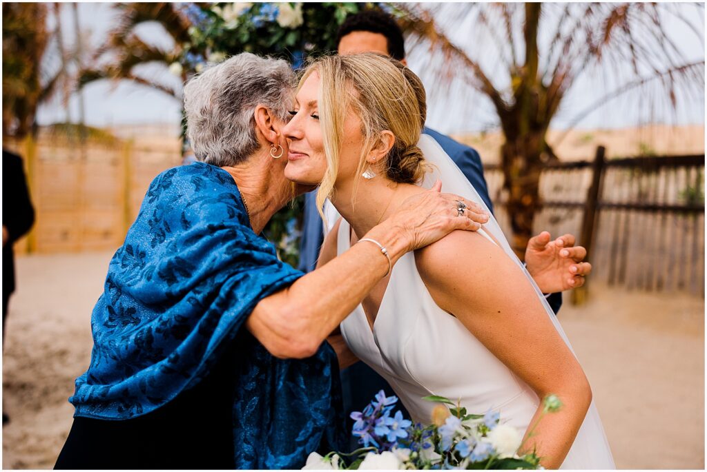 A bride hugs a family member.