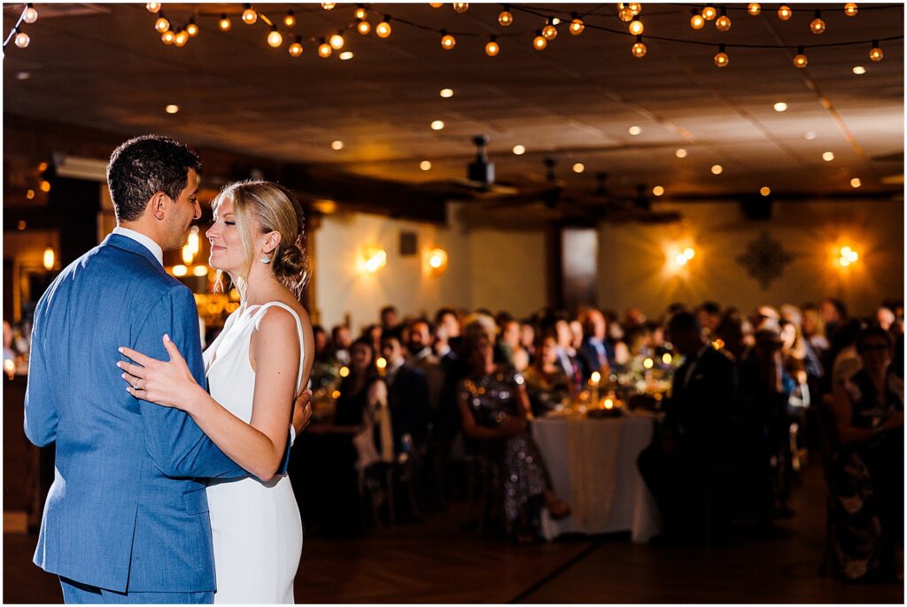 A bride and groom share a first dance at their Sea Shell Resort wedding reception.