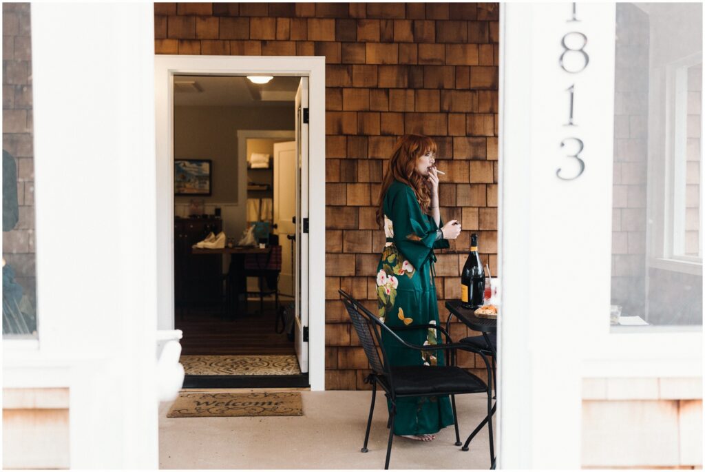 A bride applies makeup on the porch of a cottage at Good Earth Market.