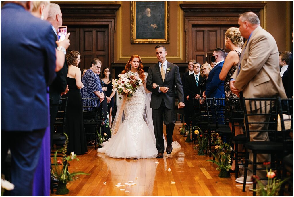 A bride walks down the aisle for her Mutter Museum wedding.