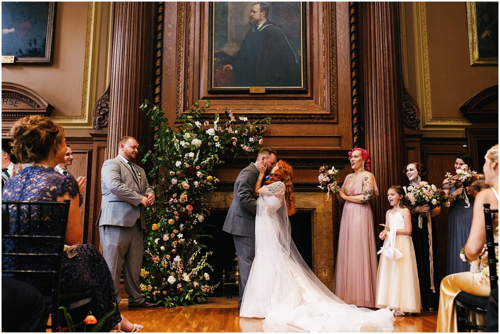 A bride and groom share their first kiss in a historic wedding venue in Philadelphia.