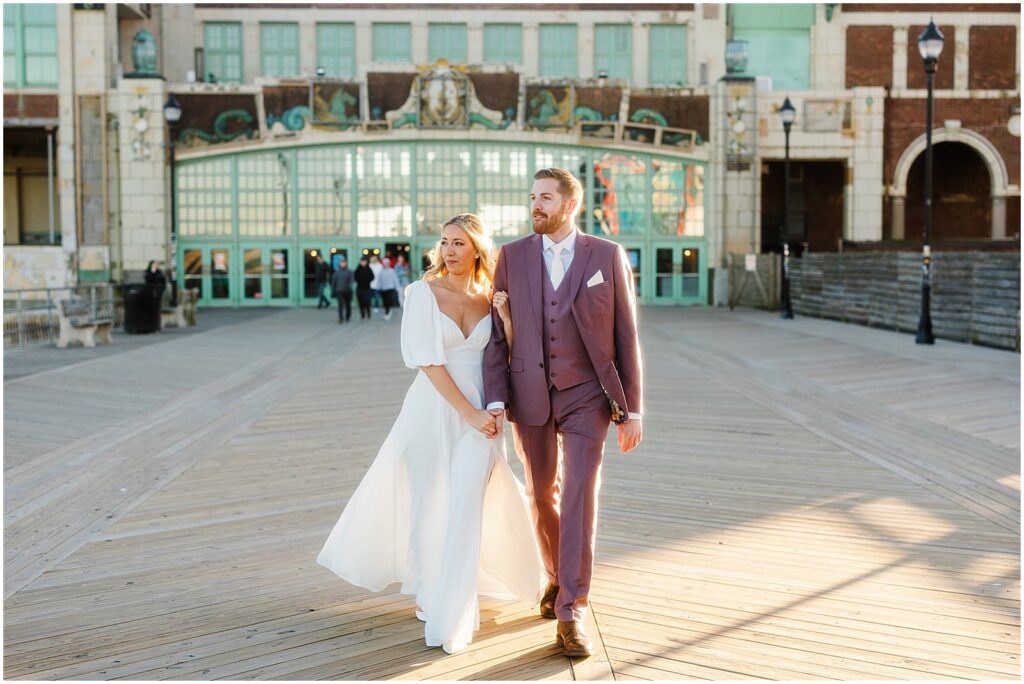 A bride and groom walk past Convention Hall on their way to a Porta Asbury Park wedding.