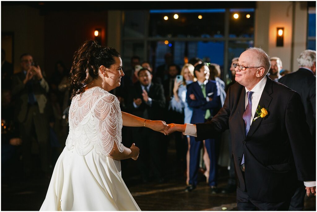 A bride dances with her father.