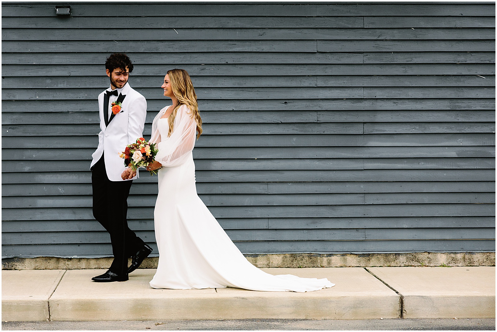A bride and groom walk past Parker's Garage LBI after their wedding ceremony.