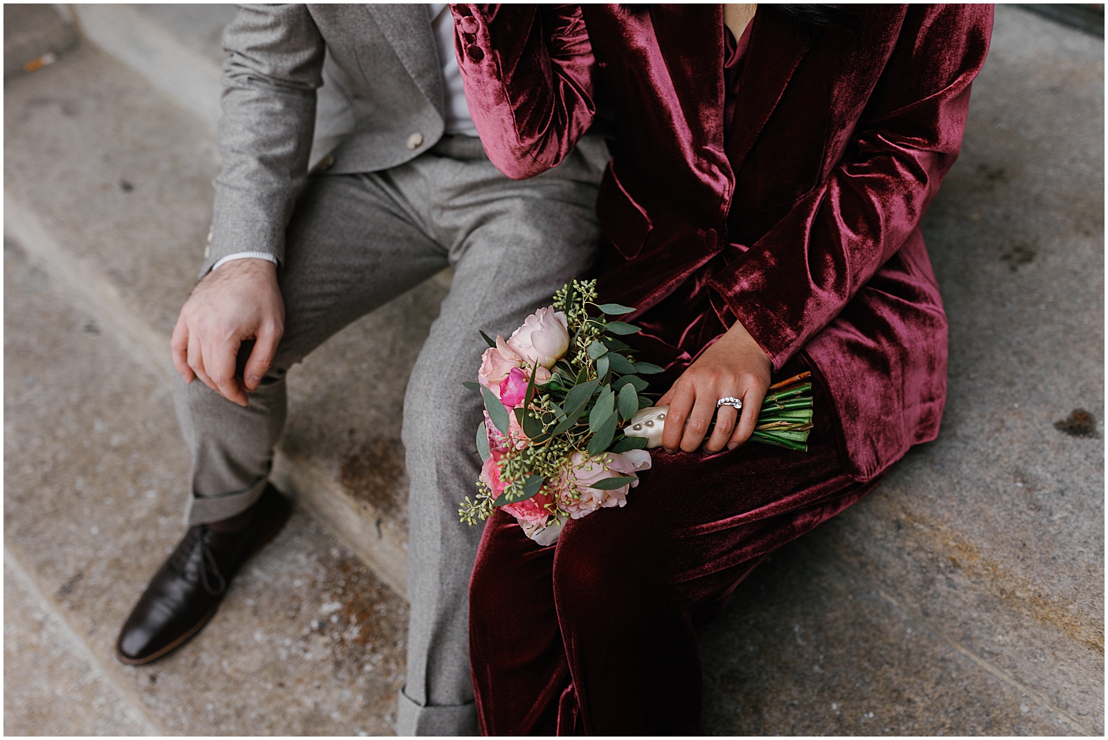 A man and woman sit side by side on a step after their NYC elopement in January.