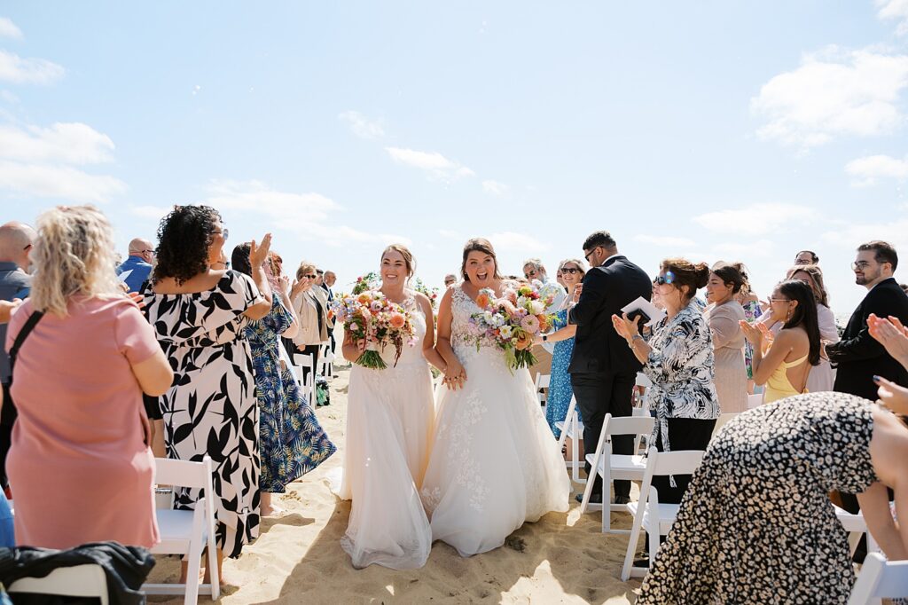 A newly married couple comes down the aisle at an Asbury Park wedding venue.